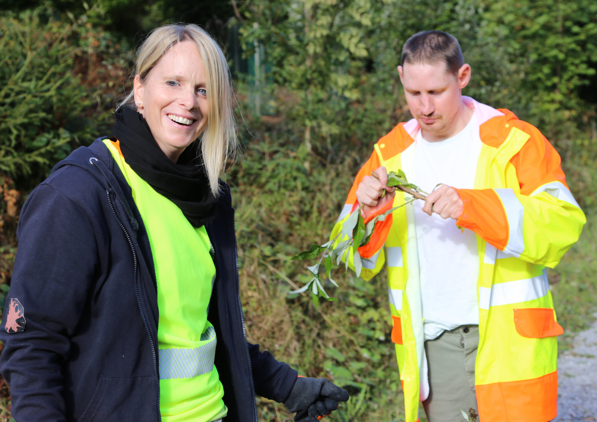 Pia Karrasch und ein Klient mit entferntem Pflanzenmaterial beim WaldWerk-Einsatz